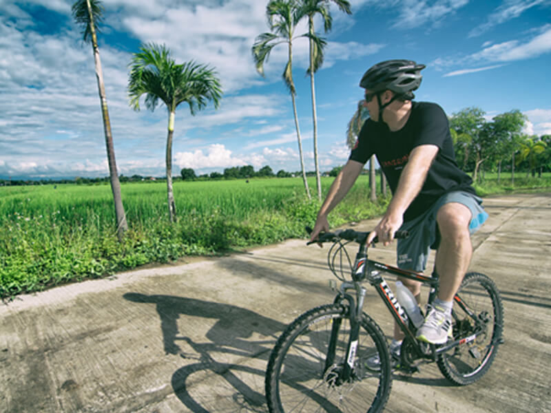 Man rides bike outside Mae Rim rehab center