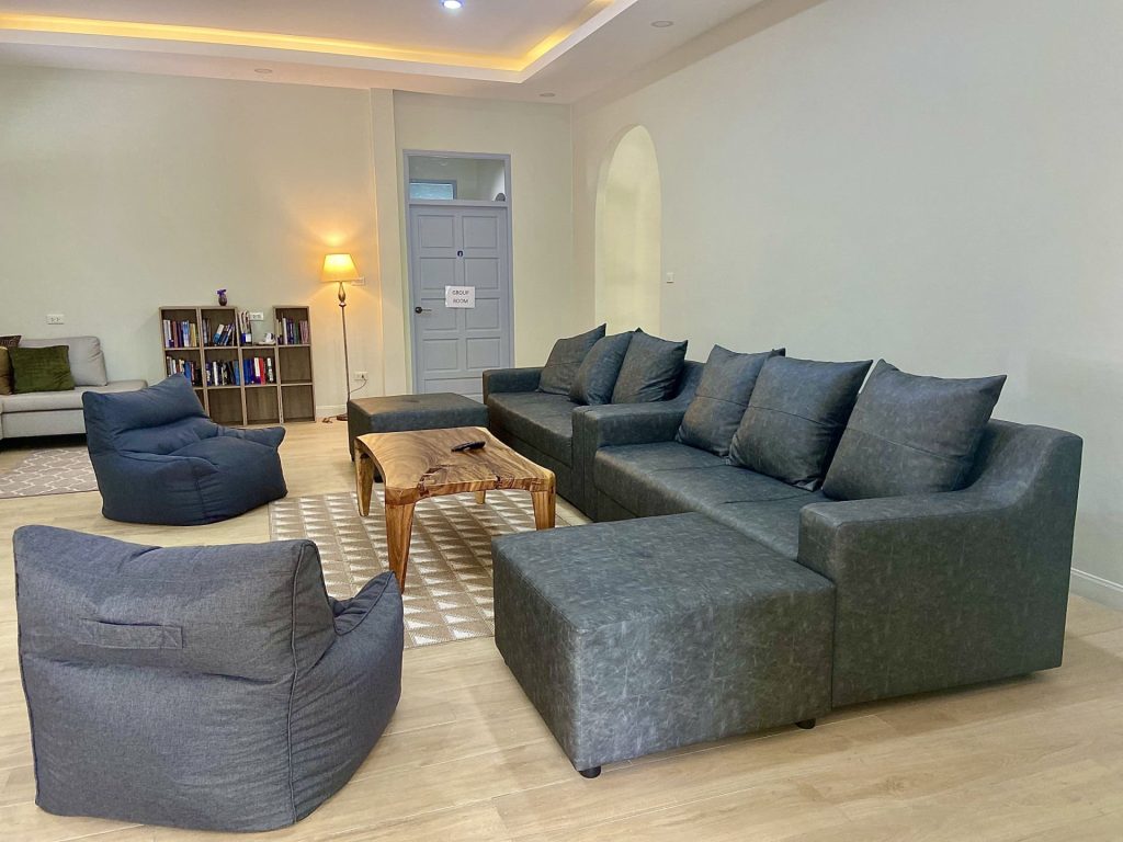 Group counseling facility with wooden floor and soft furnishings