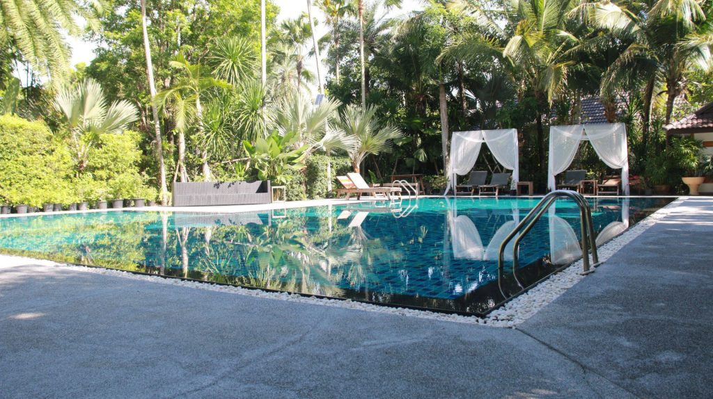 Deep blue swimming pool with shade at One Step Rehab